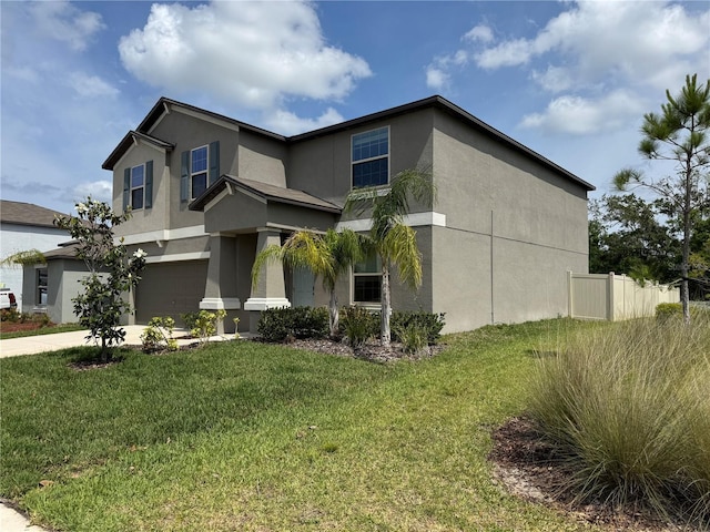 view of front of house featuring a garage, stucco siding, and a front lawn
