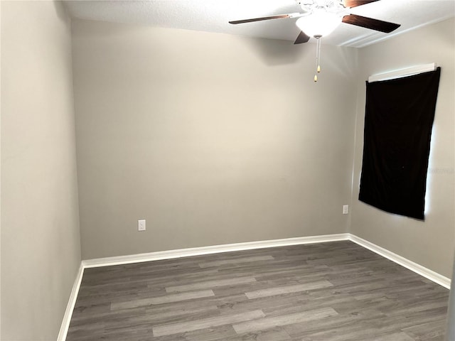 unfurnished room with baseboards, ceiling fan, and wood finished floors