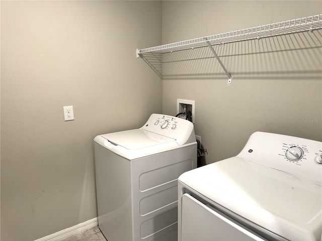 laundry area with separate washer and dryer, laundry area, and baseboards