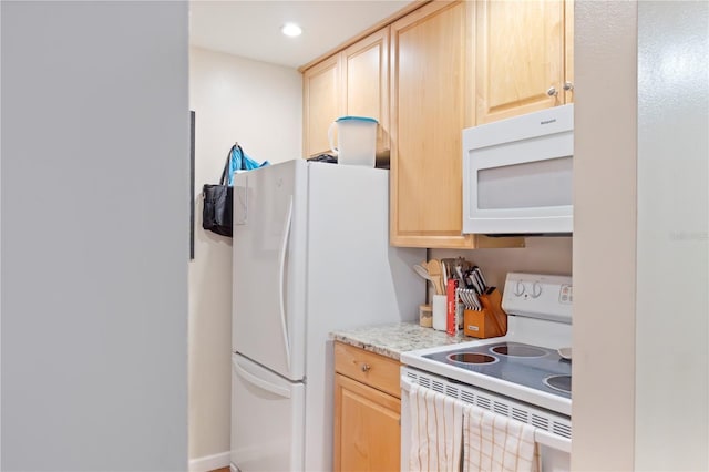 kitchen featuring light countertops, light brown cabinets, recessed lighting, and white appliances