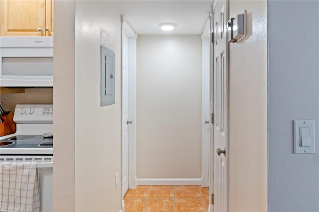 corridor with electric panel, baseboards, and light tile patterned floors