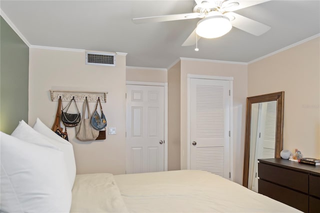 bedroom featuring a closet, visible vents, a ceiling fan, and ornamental molding