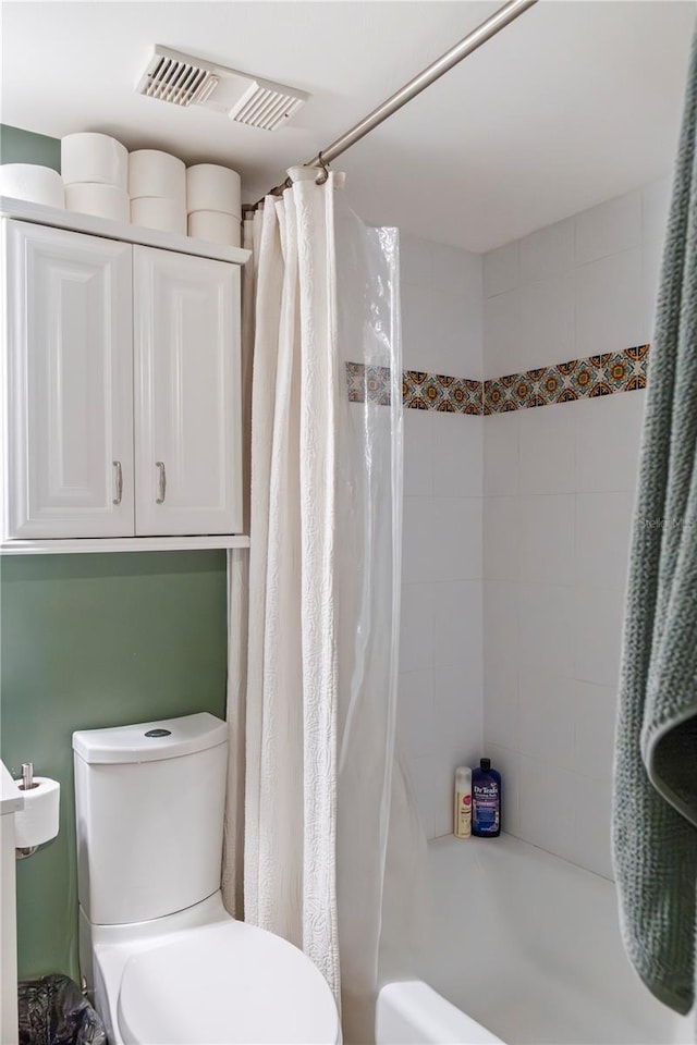 bathroom with toilet, shower / bath combo with shower curtain, and visible vents