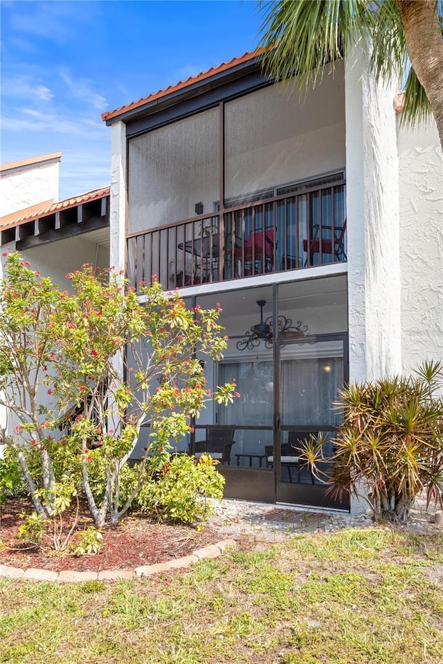 property entrance with stucco siding and a balcony