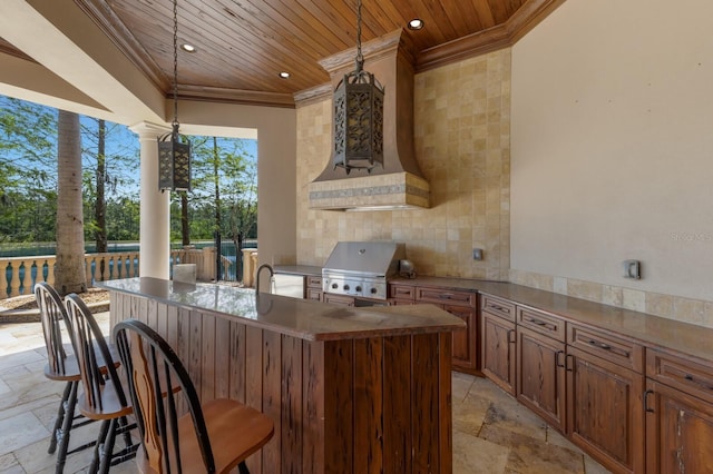 view of patio / terrace featuring outdoor wet bar, an outdoor kitchen, and area for grilling