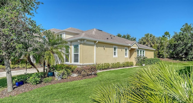 11847 Meadowgate Pl, Lakewood Ranch, FL 34211 - view of side of property with stucco siding and a lawn
