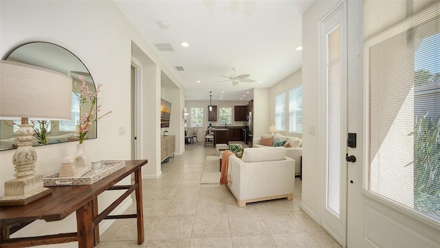 11847 Meadowgate Pl, Lakewood Ranch, FL 34211 - corridor featuring baseboards, visible vents, light tile patterned flooring, and recessed lighting