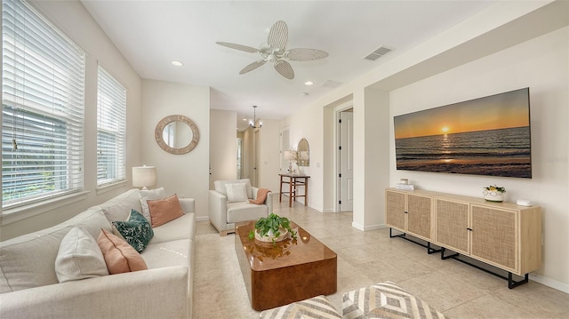 11847 Meadowgate Pl, Lakewood Ranch, FL 34211 - living room with plenty of natural light, visible vents, baseboards, and ceiling fan with notable chandelier