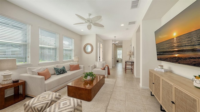 11847 Meadowgate Pl, Lakewood Ranch, FL 34211 - living room featuring light tile patterned floors, a healthy amount of sunlight, visible vents, and ceiling fan with notable chandelier
