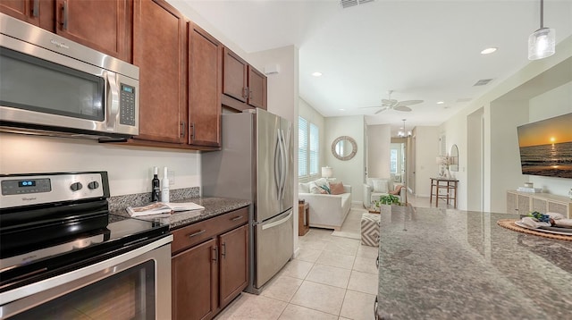 11847 Meadowgate Pl, Lakewood Ranch, FL 34211 - kitchen featuring dark stone counters, light tile patterned floors, a ceiling fan, pendant lighting, and appliances with stainless steel finishes