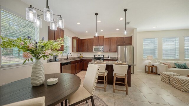 11847 Meadowgate Pl, Lakewood Ranch, FL 34211 - kitchen featuring a center island, stainless steel appliances, recessed lighting, and a sink