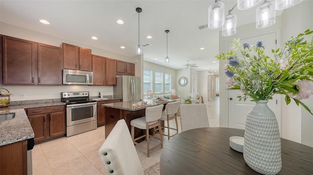 11847 Meadowgate Pl, Lakewood Ranch, FL 34211 - kitchen with light tile patterned floors, recessed lighting, visible vents, and stainless steel appliances
