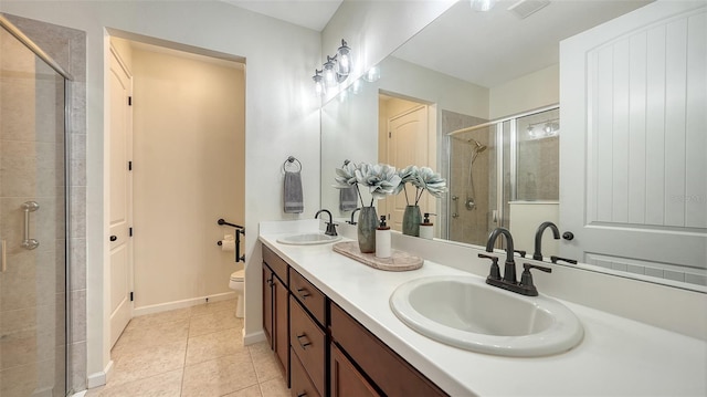 11847 Meadowgate Pl, Lakewood Ranch, FL 34211 - bathroom featuring tile patterned floors, toilet, a stall shower, and a sink