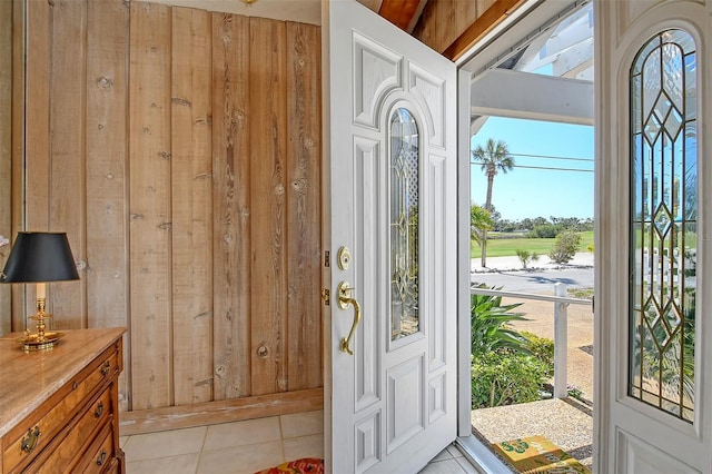 621 Ivanhoe Ln, Holmes Beach, FL 34217 - entryway featuring wood walls and light tile patterned floors