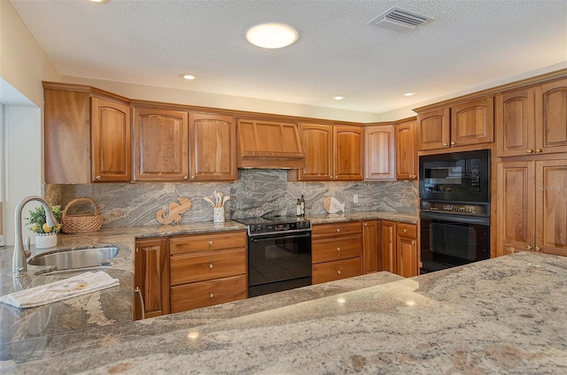 621 Ivanhoe Ln, Holmes Beach, FL 34217 - kitchen with light stone counters, a sink, black appliances, premium range hood, and visible vents