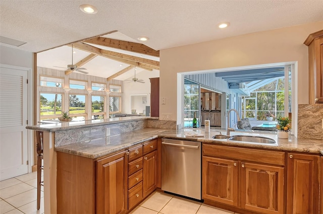 621 Ivanhoe Ln, Holmes Beach, FL 34217 - kitchen with stainless steel dishwasher, a ceiling fan, a sink, brown cabinets, and vaulted ceiling with beams