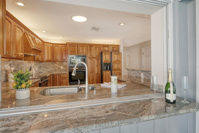 621 Ivanhoe Ln, Holmes Beach, FL 34217 - kitchen featuring paneled refrigerator, a sink, stone countertops, backsplash, and visible vents