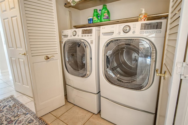 621 Ivanhoe Ln, Holmes Beach, FL 34217 - laundry room featuring washing machine and clothes dryer, light tile patterned floors, and laundry area