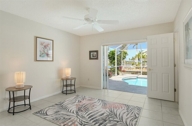 621 Ivanhoe Ln, Holmes Beach, FL 34217 - sitting room with light tile patterned flooring, baseboards, a swimming pool, ceiling fan, and a sunroom
