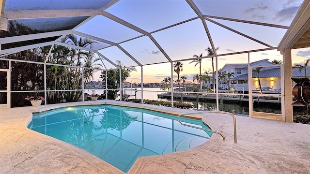621 Ivanhoe Ln, Holmes Beach, FL 34217 - pool featuring glass enclosure, a patio area, and a water view