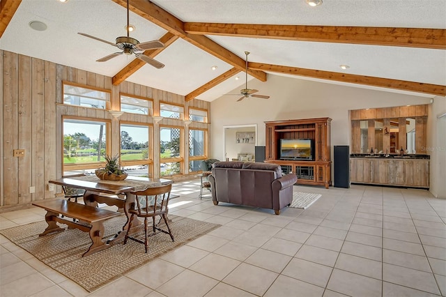 621 Ivanhoe Ln, Holmes Beach, FL 34217 - living area with light tile patterned floors, beam ceiling, ceiling fan, and high vaulted ceiling