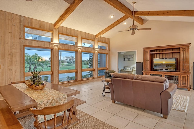 621 Ivanhoe Ln, Holmes Beach, FL 34217 - living room with ceiling fan, wood walls, light tile patterned flooring, and beam ceiling