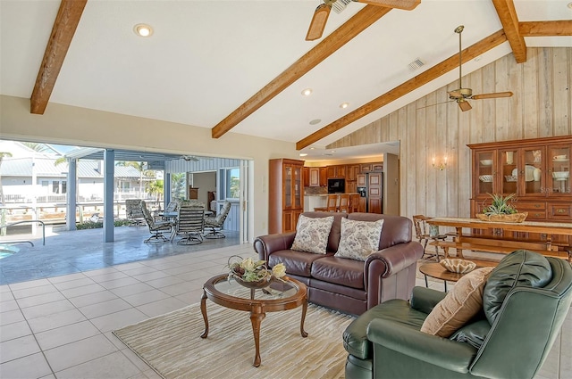 621 Ivanhoe Ln, Holmes Beach, FL 34217 - living area with wood walls, visible vents, light tile patterned flooring, lofted ceiling with beams, and ceiling fan