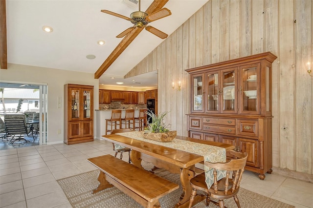 621 Ivanhoe Ln, Holmes Beach, FL 34217 - dining room with high vaulted ceiling, a ceiling fan, light tile patterned flooring, wood walls, and visible vents