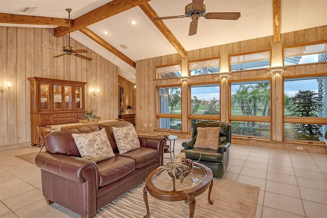 621 Ivanhoe Ln, Holmes Beach, FL 34217 - living room with wooden walls, ceiling fan, and light tile patterned floors