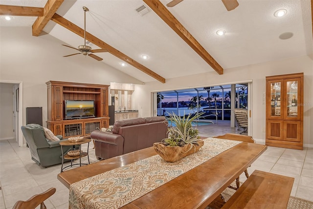 621 Ivanhoe Ln, Holmes Beach, FL 34217 - dining space with vaulted ceiling with beams, a ceiling fan, visible vents, and light tile patterned floors