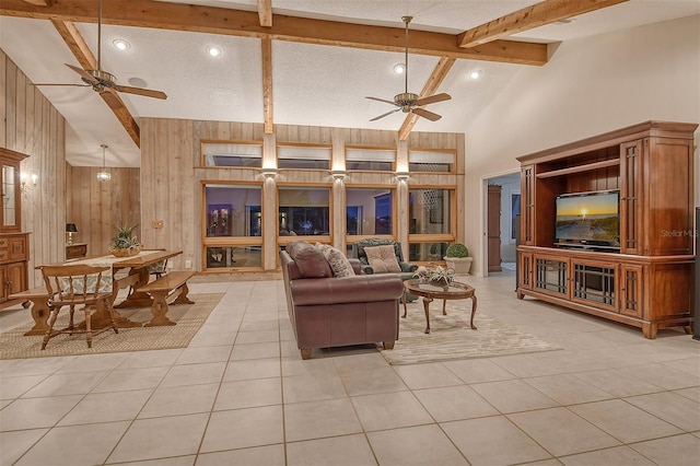 621 Ivanhoe Ln, Holmes Beach, FL 34217 - living area with beamed ceiling, a ceiling fan, high vaulted ceiling, and wood walls