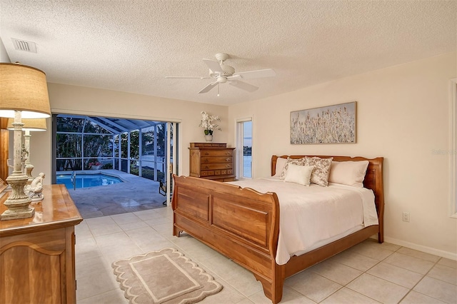 621 Ivanhoe Ln, Holmes Beach, FL 34217 - bedroom featuring a textured ceiling, access to outside, ceiling fan, a sunroom, and light tile patterned floors