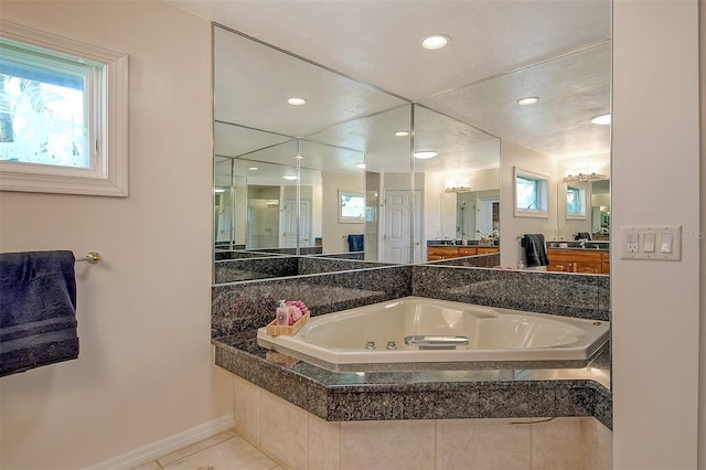 621 Ivanhoe Ln, Holmes Beach, FL 34217 - bathroom featuring baseboards, recessed lighting, tile patterned flooring, a tub with jets, and vanity