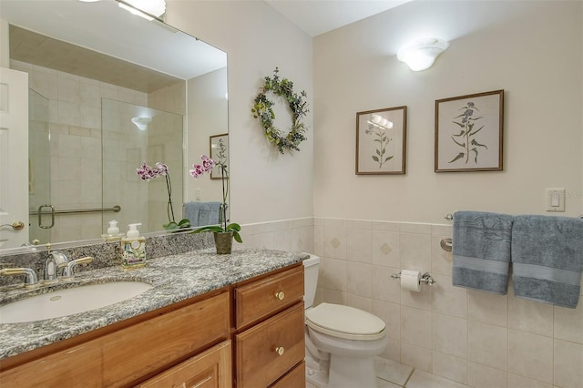 621 Ivanhoe Ln, Holmes Beach, FL 34217 - bathroom featuring tile patterned floors, toilet, vanity, tile walls, and tiled shower