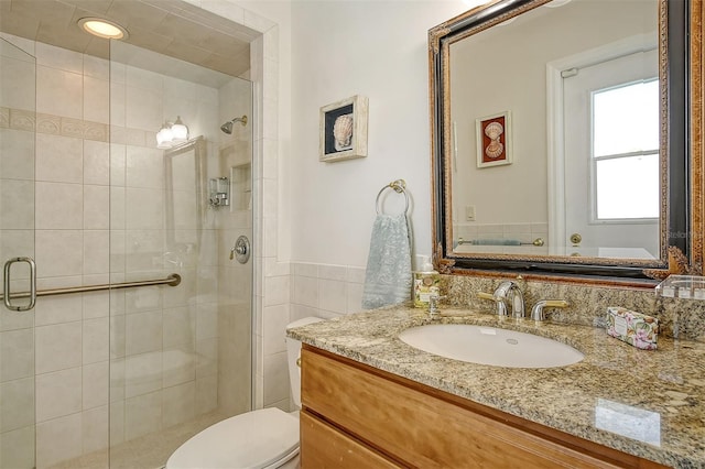 621 Ivanhoe Ln, Holmes Beach, FL 34217 - bathroom with wainscoting, toilet, vanity, and a stall shower