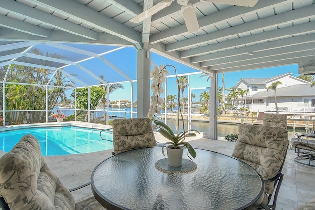 621 Ivanhoe Ln, Holmes Beach, FL 34217 - outdoor pool featuring glass enclosure, a patio, a water view, and ceiling fan