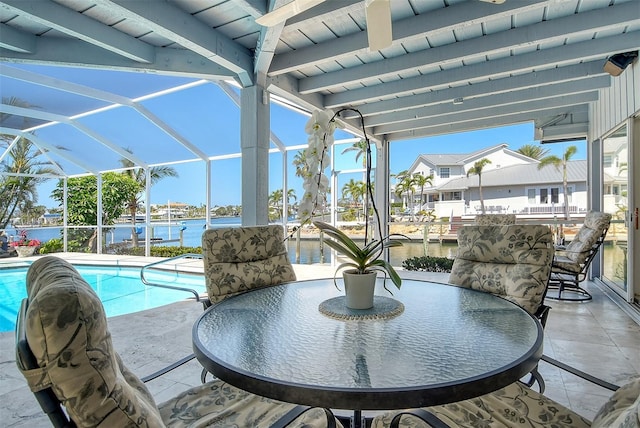 621 Ivanhoe Ln, Holmes Beach, FL 34217 - view of patio / terrace with an outdoor pool, outdoor dining space, glass enclosure, and a water view