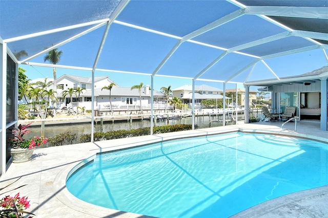 621 Ivanhoe Ln, Holmes Beach, FL 34217 - pool featuring a dock, glass enclosure, a residential view, a water view, and a patio