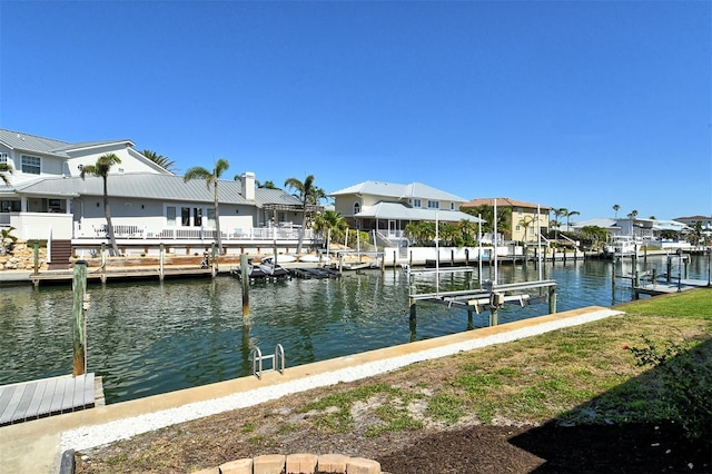 621 Ivanhoe Ln, Holmes Beach, FL 34217 - view of dock featuring a water view, a residential view, and boat lift