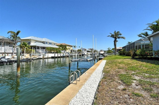 621 Ivanhoe Ln, Holmes Beach, FL 34217 - view of dock with a residential view, a water view, and boat lift