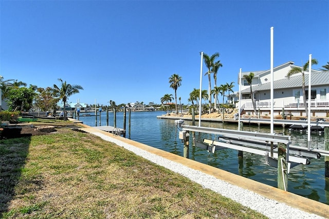 621 Ivanhoe Ln, Holmes Beach, FL 34217 - view of dock featuring boat lift and a water view