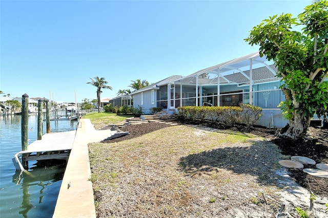 621 Ivanhoe Ln, Holmes Beach, FL 34217 - view of dock featuring a lanai and a water view