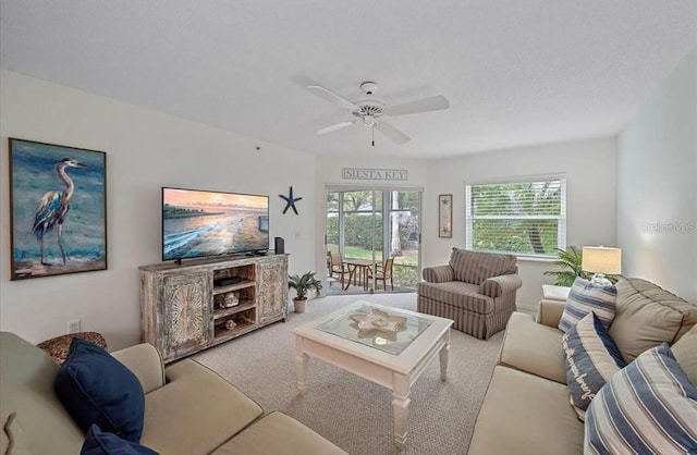 carpeted living area featuring ceiling fan