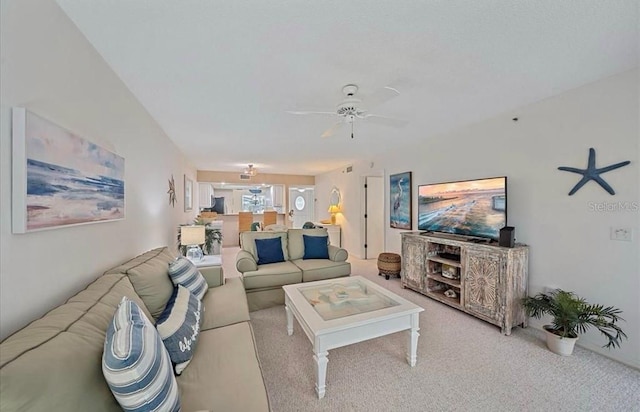 living area featuring ceiling fan and carpet
