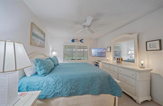 bedroom featuring a ceiling fan, baseboards, and light colored carpet