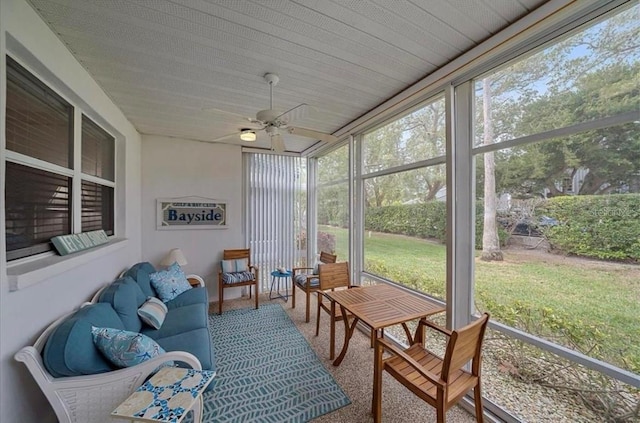 sunroom featuring ceiling fan, a wealth of natural light, and an outdoor hangout area
