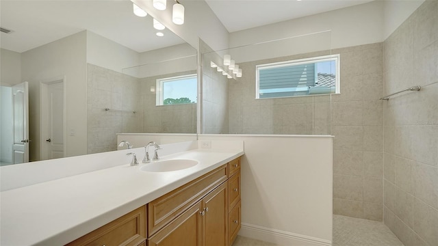 bathroom with a walk in shower and vanity