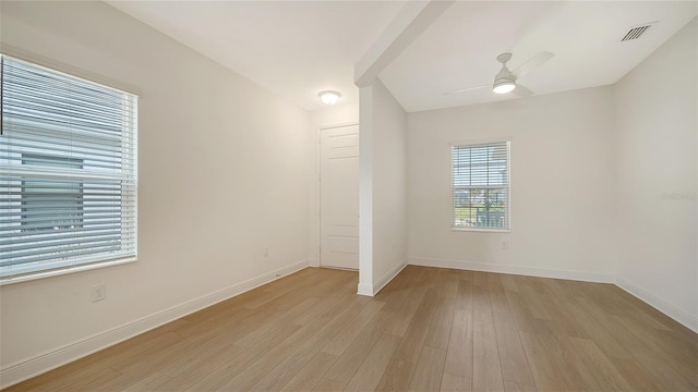 spare room with light wood-type flooring, baseboards, and ceiling fan