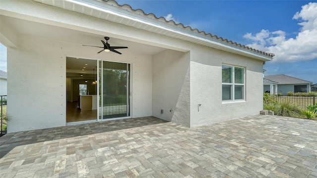 view of patio with a ceiling fan and fence
