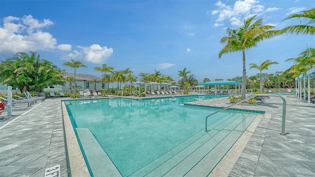 community pool with fence and a patio